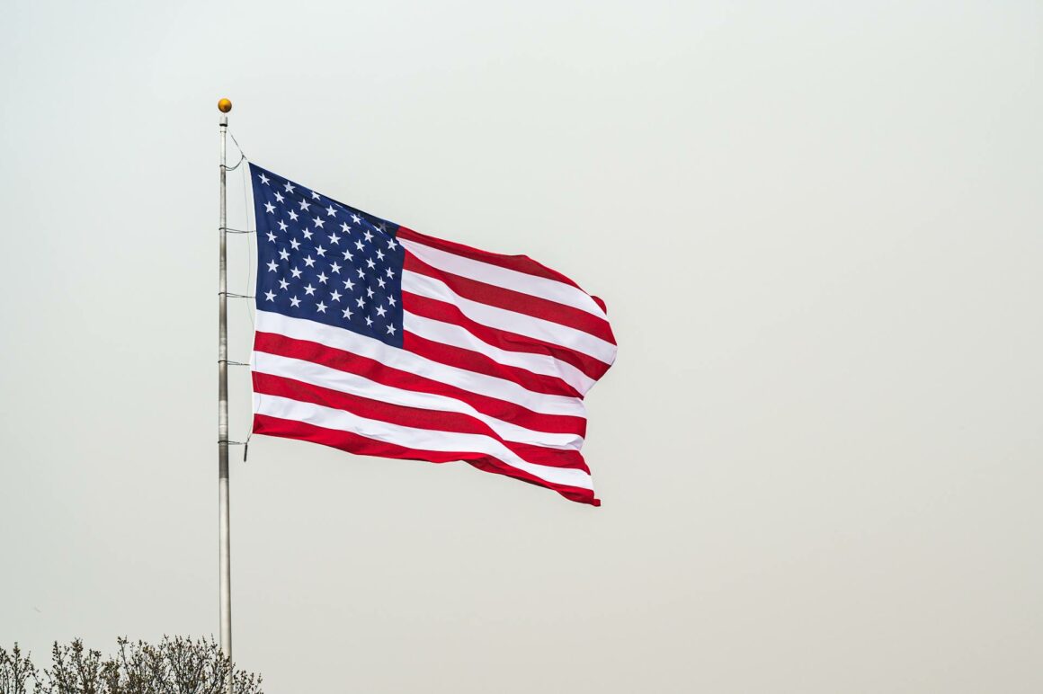 american flag against gray sky