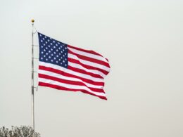 american flag against gray sky