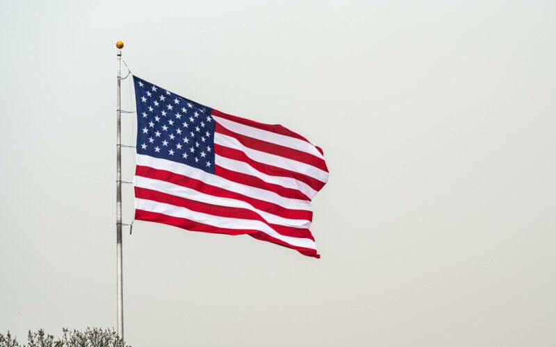 american flag against gray sky